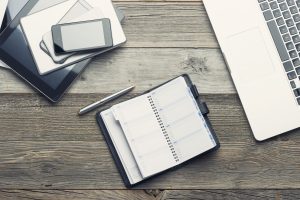 desk with phone laptop and planner iStock 485373522 financial planner for doctors