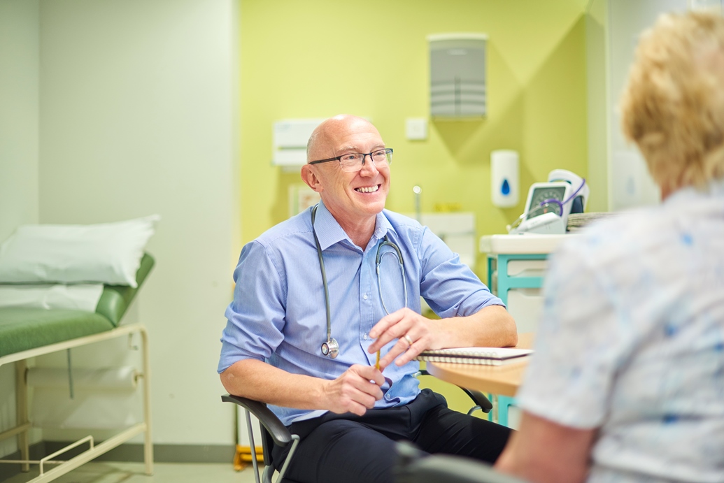 Consulting doctor talking to a patient after setting up a private practice in Australia