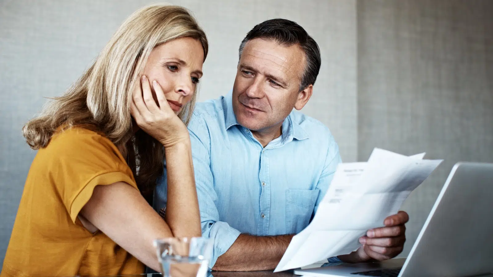 Couple reviewing income protection changes on laptop