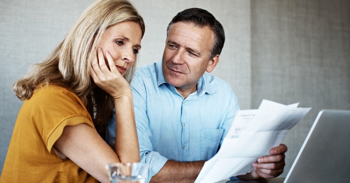 Home 15 Couple-reviewing-income-protection-policy-changes-on-laptop