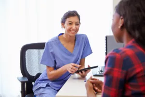 Tax and Accounting for Doctors In Training 14 young female doctor with patient iStock 489341812 buyers advocate for doctors