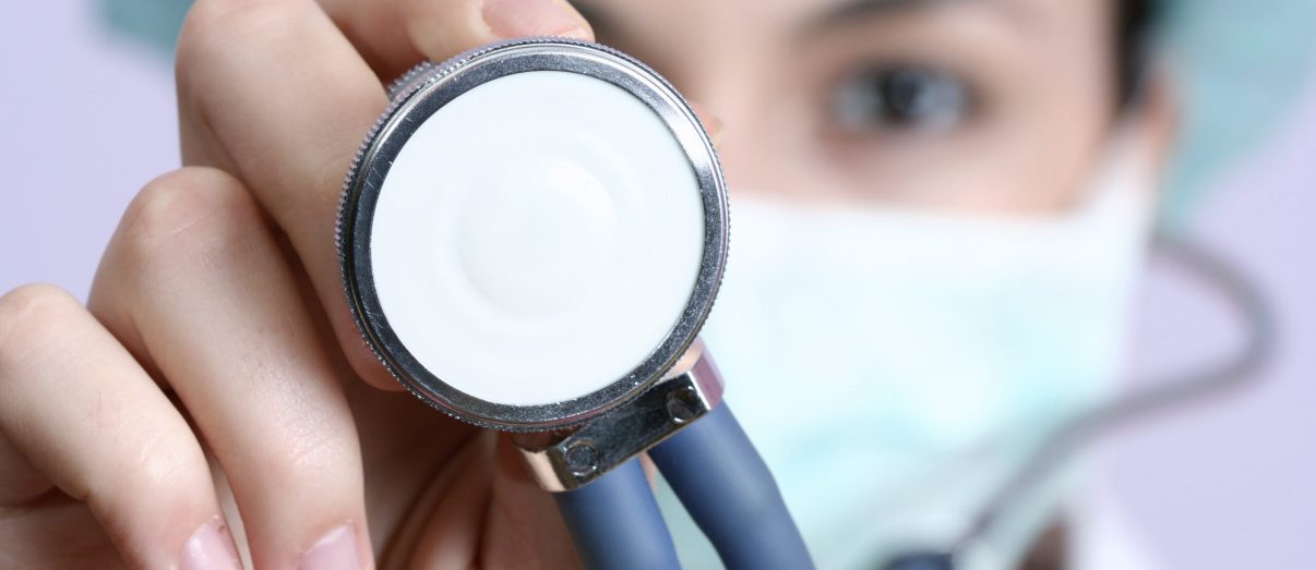 Doctor performing health check with stethoscope