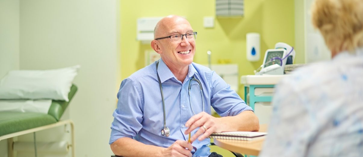 Consulting doctor talking to a patient after setting up a private practice in Australia