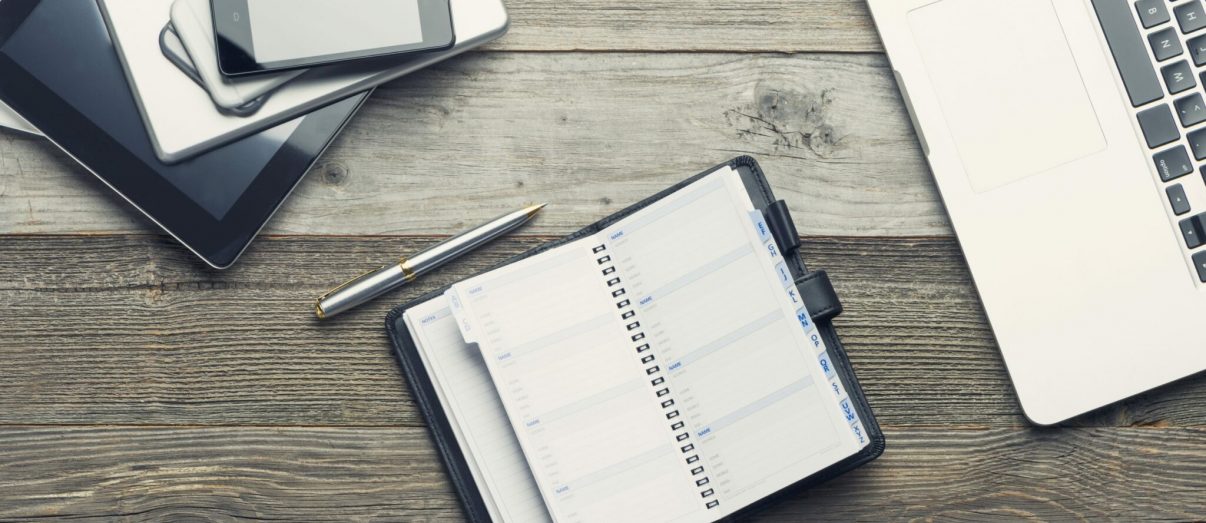 desk-with-phone-laptop-and-planner-iStock-485373522