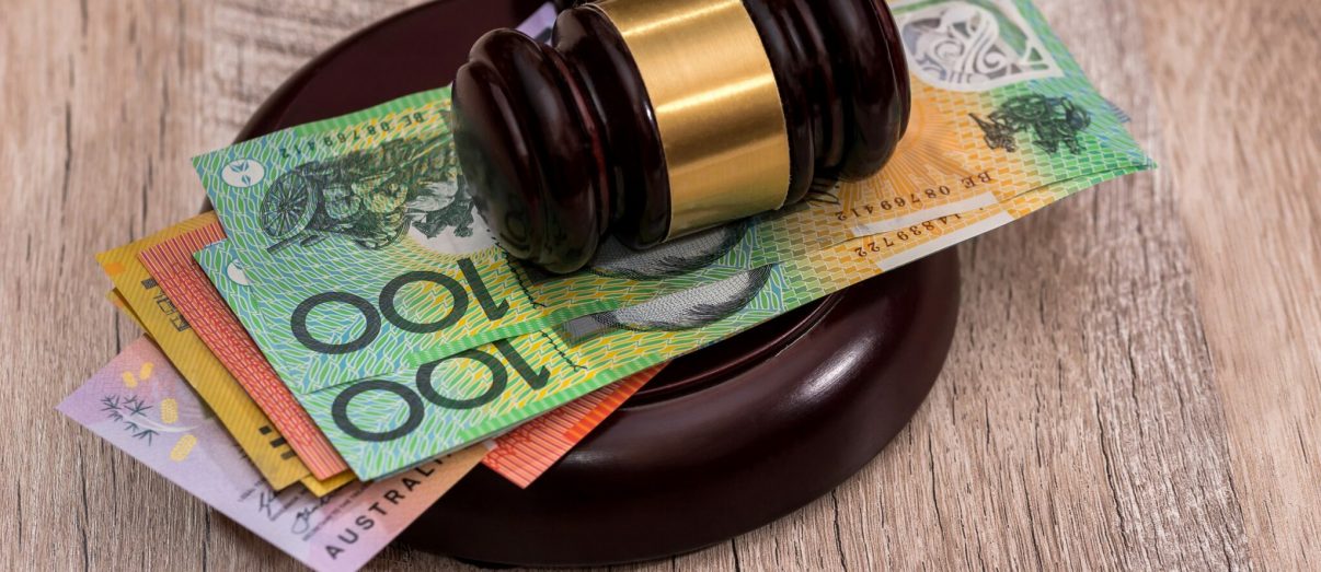 Australian dollars under judge's gavel close up