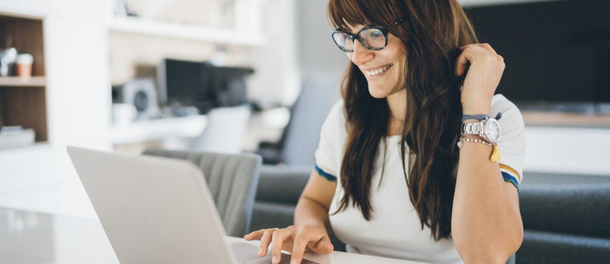 Young woman enjoying home office using laptop