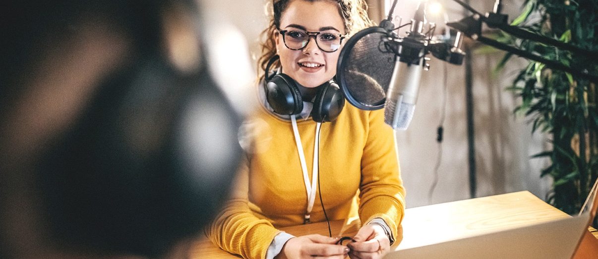 Young woman recording a podcast