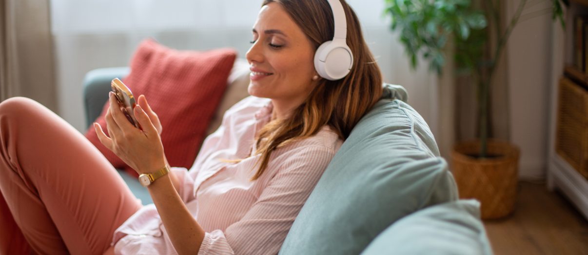 The image describes a medical student or intern listening to medical podcasts on her headphones.