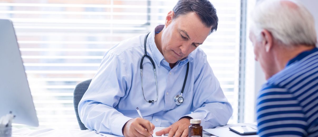 Doctor prescribing medicine to senior patient in clinic