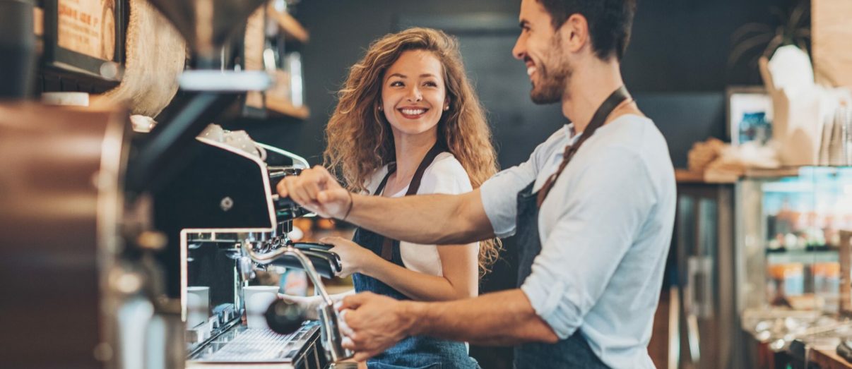 Couple of baristas working in a coffee shop