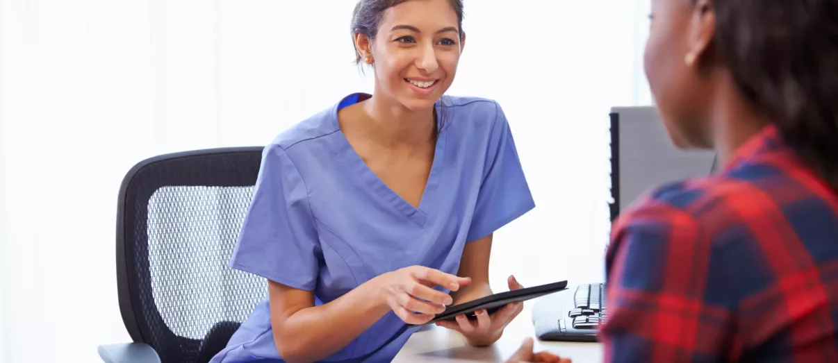 Patient Having Consultation With Female Doctor In Office