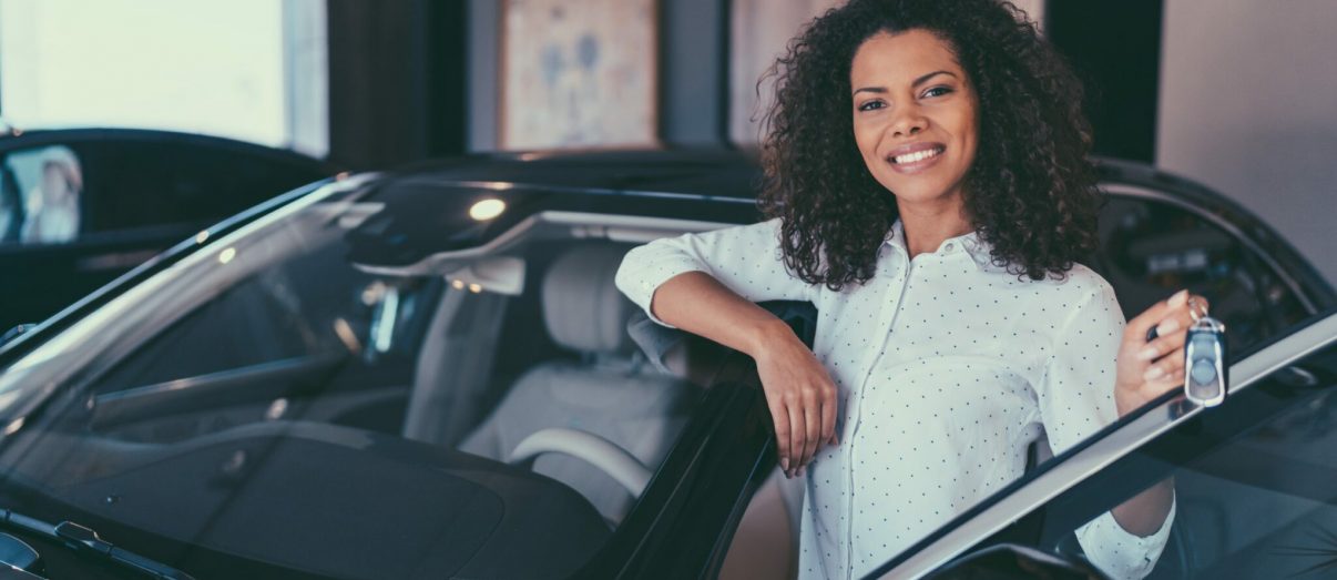 young-woman-buying-new-car-iStock-1039931504